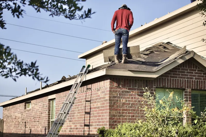 Professional roofer working on a residential roof in Kilbourne